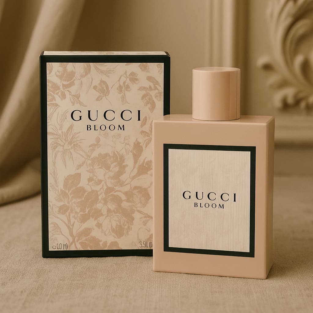 Gucci Bloom perfume bottle and packaging on a beige surface
