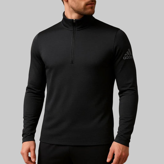 Black Adidas long-sleeve athletic top on a neutral background