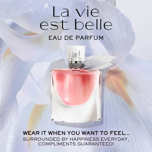 Perfume bottle with 'La vie est belle' text and floral elements on a light background