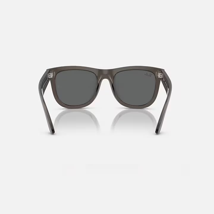 Sunglasses with dark lenses and gray frame on a white background
