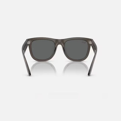 Sunglasses with dark lenses and gray frame on a white background