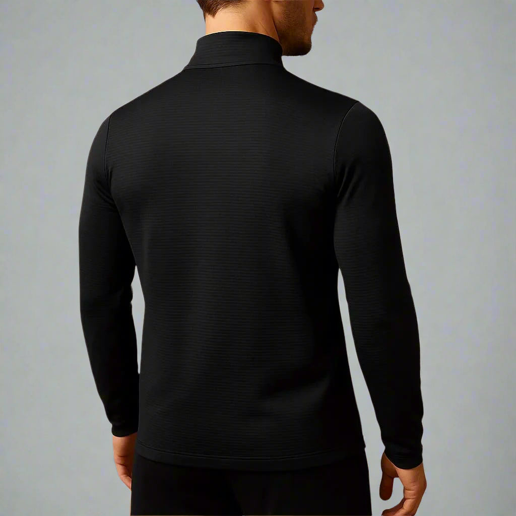 Person wearing a black long-sleeve shirt against a gray background