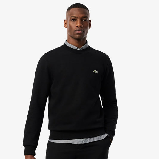 Man wearing a black sweatshirt with a brand logo on a white background
