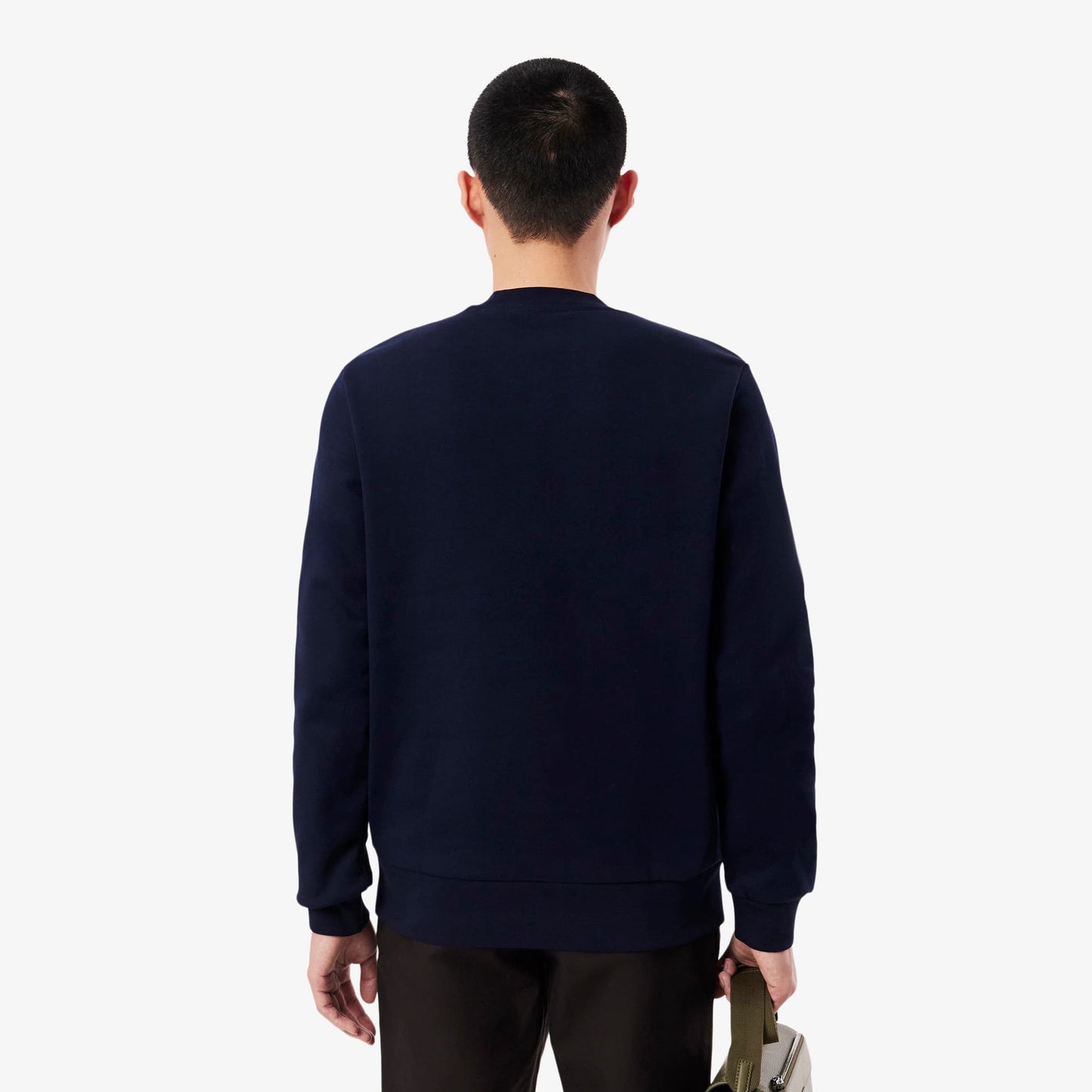 Person wearing a navy blue sweatshirt on a white background