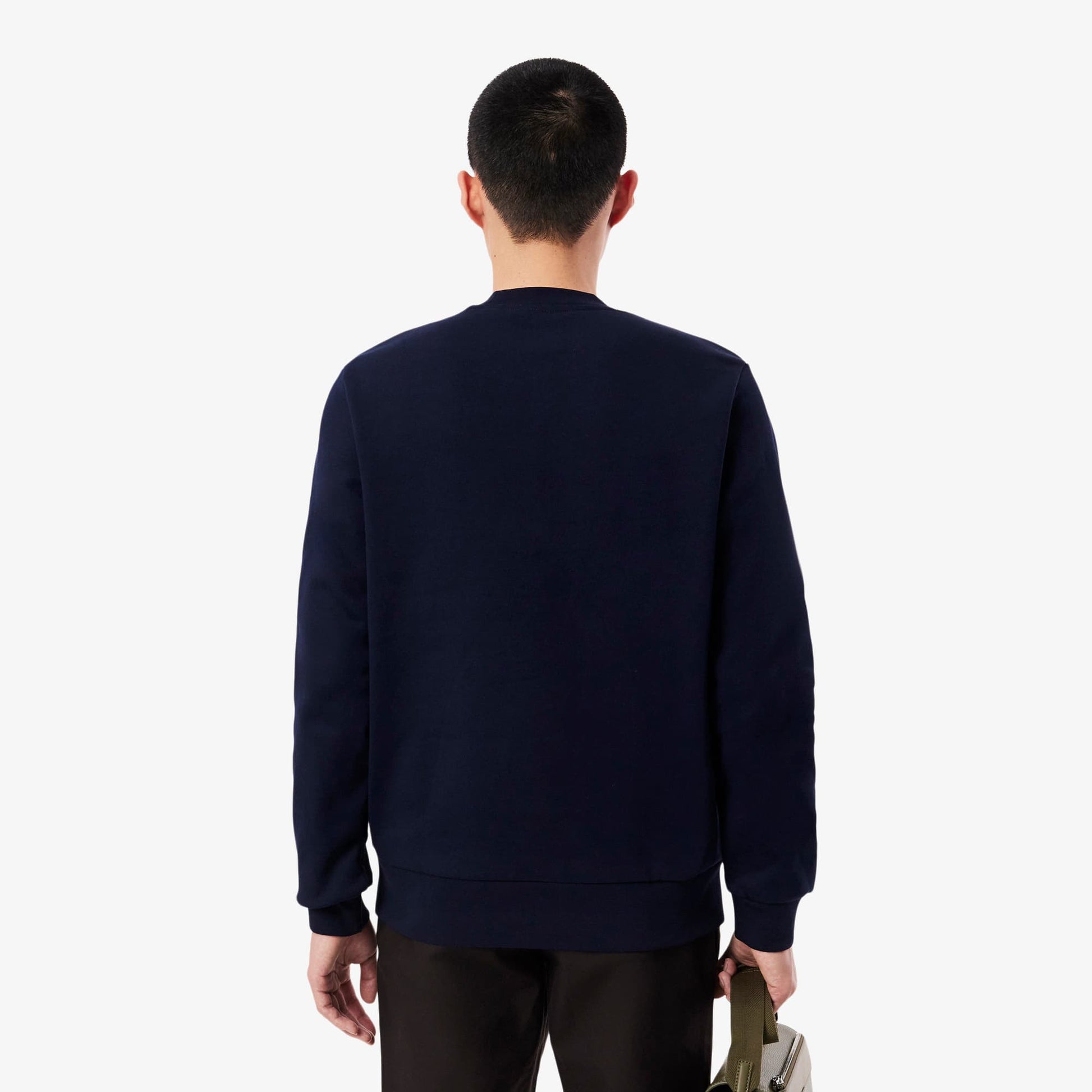 Person wearing a navy blue sweatshirt on a white background