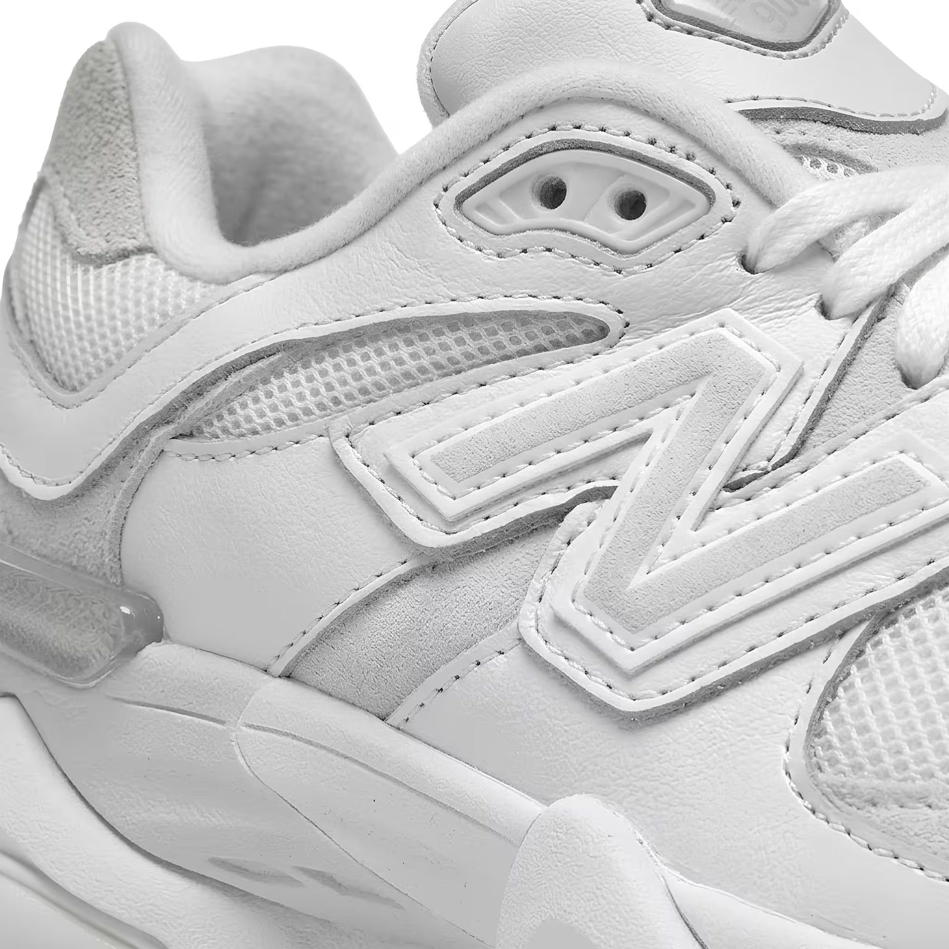 Close-up of a white new balance 9060 sneaker with visible new balance brand logo macro