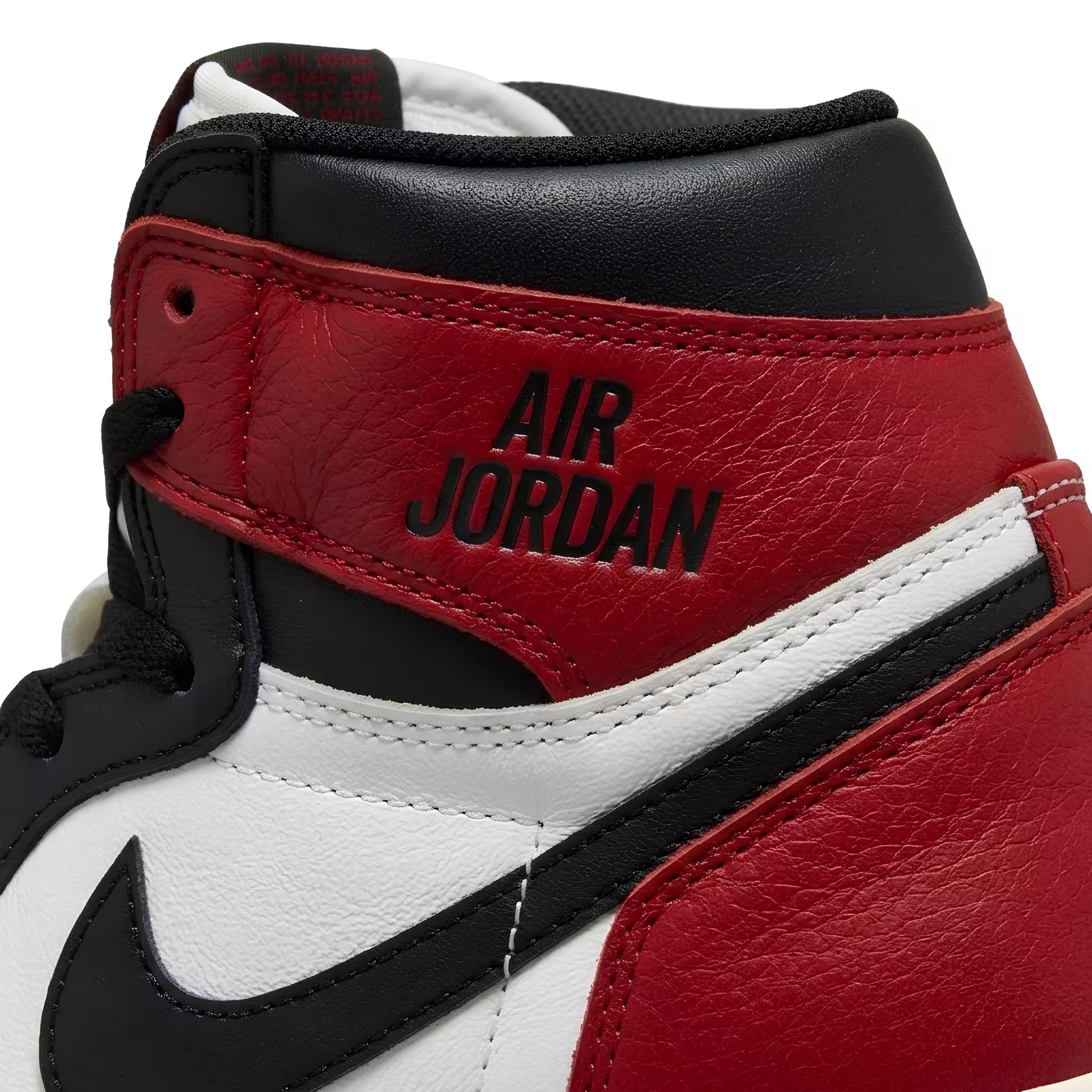 Close-up of a red, black, and white sneaker with 'Air Jordan' branding.