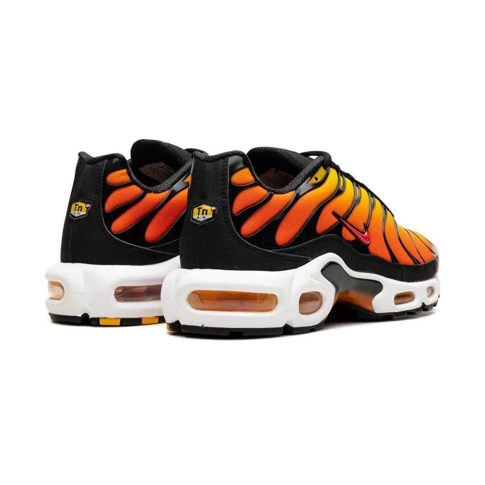 Black and orange sneakers with a tiger stripe pattern on a white background