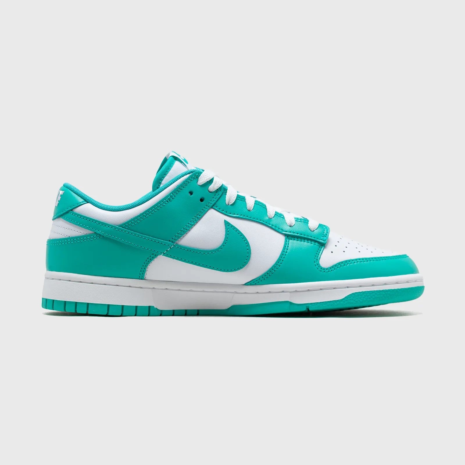 Teal and white sneaker with Nike logo on a light gray background