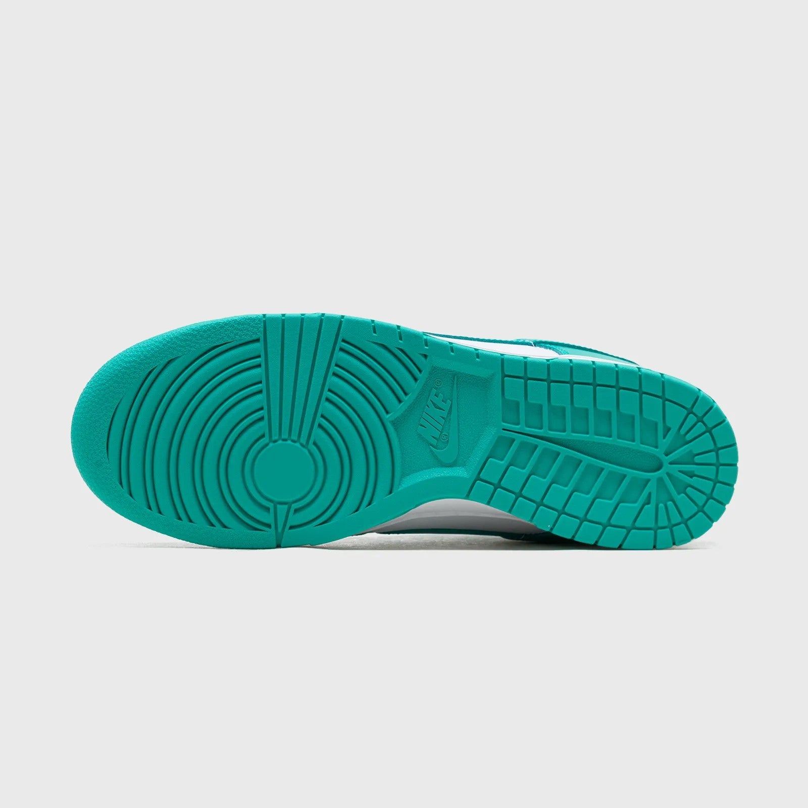 Teal sole of a sneaker on a light gray background