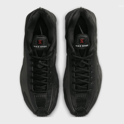 Pair of black Nike Shox sneakers on a light gray background