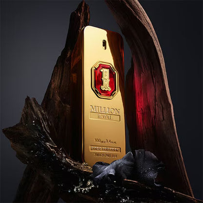 Gold bottle of Million Royale perfume with a red cap on a dark background