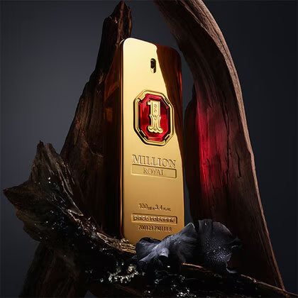 Gold bottle of Million Royale perfume with a red cap on a dark background